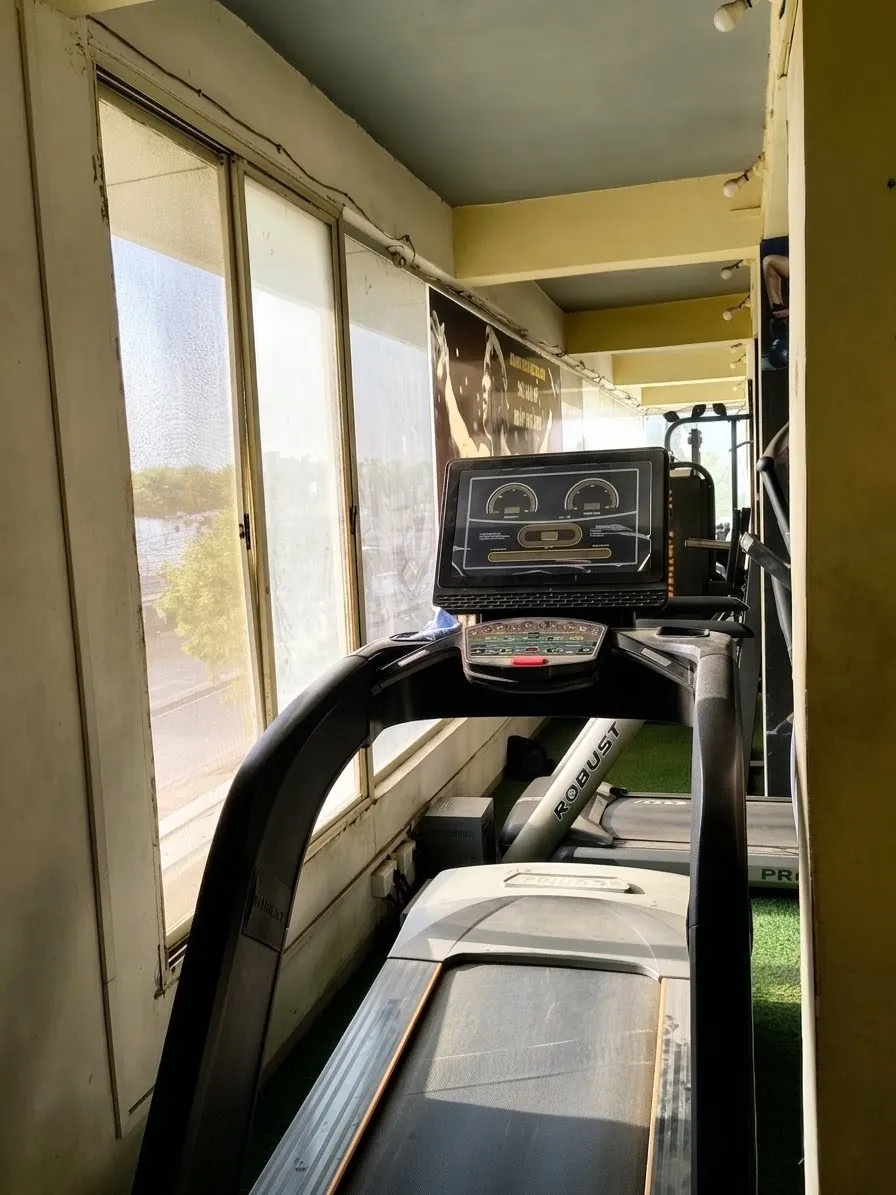 Cardio zone with elliptical trainer and stationary bike at Kesari Health Club