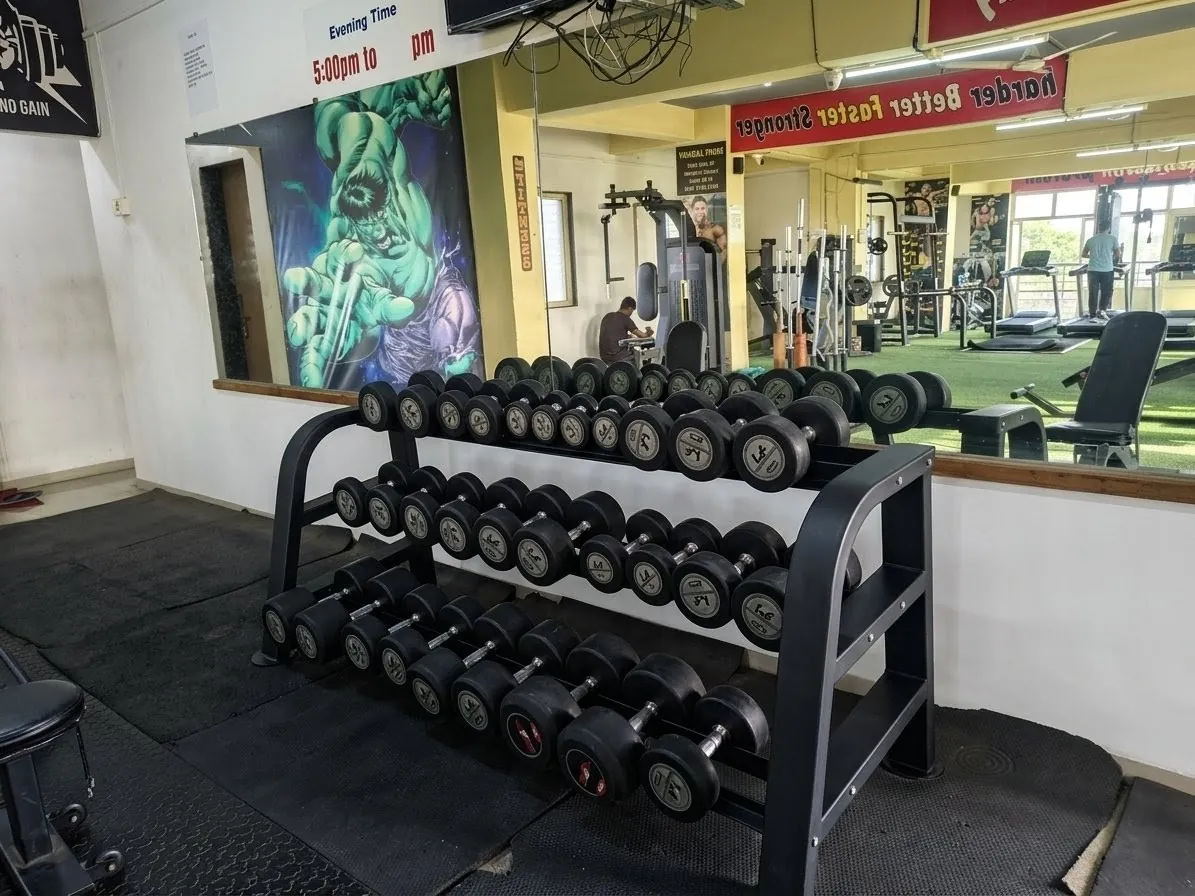 Strength training zone with barbells and inclined bench at Kesari Health Club